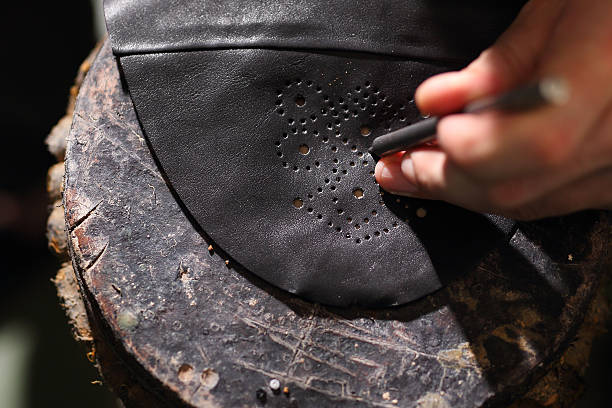 Shoemaker makes chisel holes in the skin grain